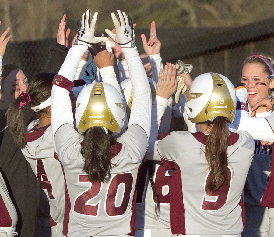 The softball team cheers during a game this past week