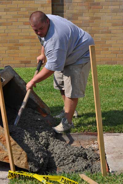 Construction workers start work diligently on Friday morning to repair sidewalks.
