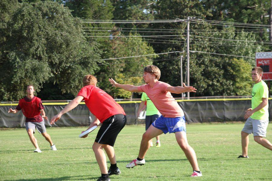Senior Ben Wilson attempts to take the Frisbee from a Kappa Sig player.