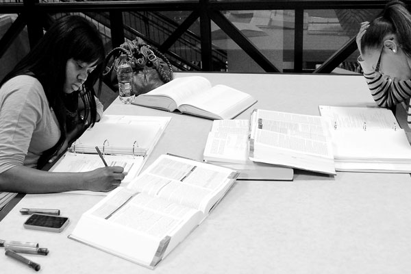 Two students read at one of the many study areas in the university’s library during a late-night study session.