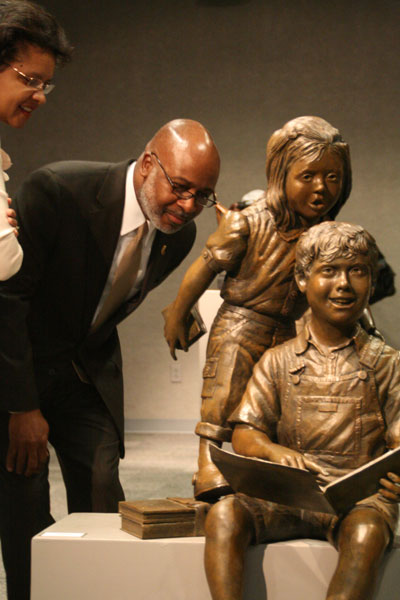 Vice Pres. of Student Life Wendell Brumfield admires one of Gregory Johnson’s bronze sculptures at the exhibit Monday.