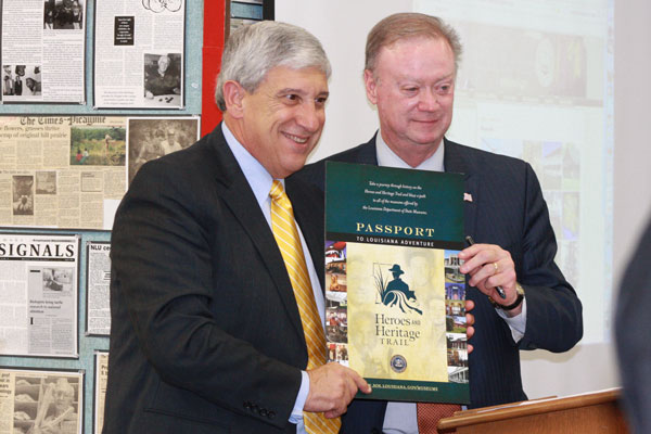President Nick Bruno (left) and Secretary of State Tom Schedler (right) pose with the Heroes and Heritage Trail logo.