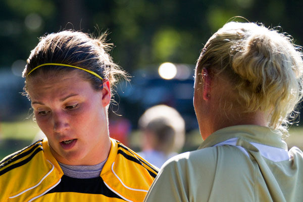 Hannah Linzay (left) looks away as head coach Stacy Lamb (right) talks.