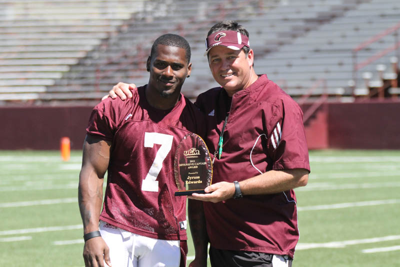 Coach Berry poses with a player