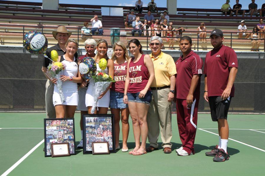 Seniors Vivian Polak (left) and Monica Winkel (right) are presented with flowers, balloons and a picture representation of their careers at ULM during the tennis teams senior day at Heard Stadium.