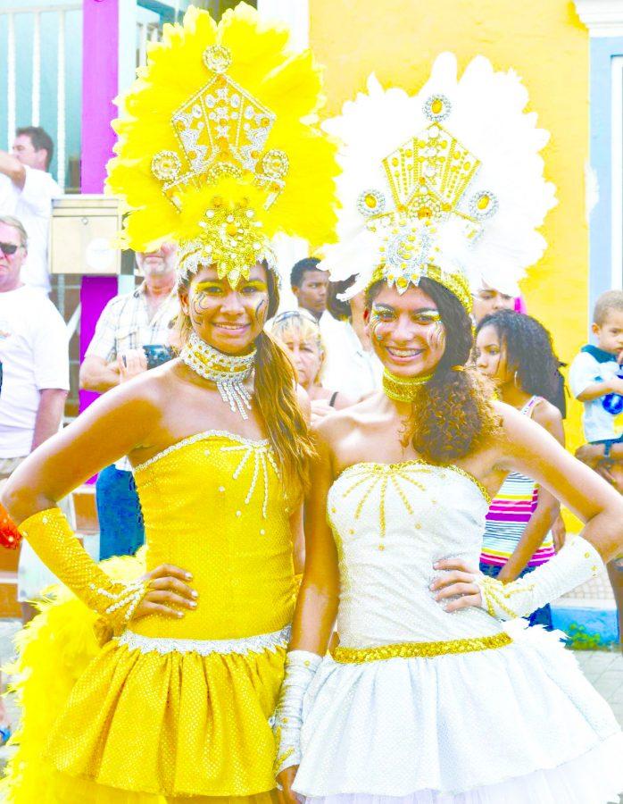 Kalie Finies (left) and best friend Julia (right) dressed in festive wear at annual Carnival parade to celebrate traditional Dutch custom on Bonaire’s main street in Caribbean Netherlands.