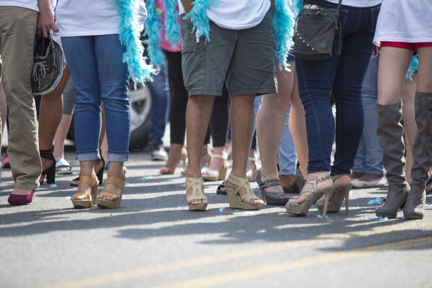 Male+and+female+students+strut+their+heels+in+this+years+Walk+a+Mile+in+Her+Shoes+sexual+abuse+awareness+walk.+Photo+by+Siddharth+Gaulee.