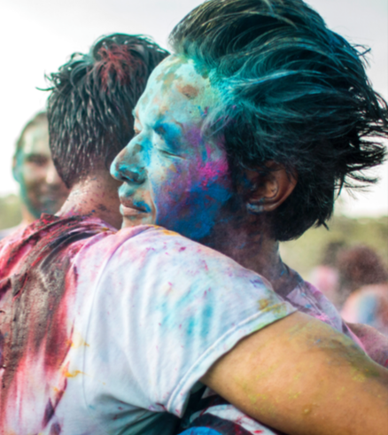 Kiran Dangol hugs a friend at Holi during International Week. Photo by Prajal Prasai.