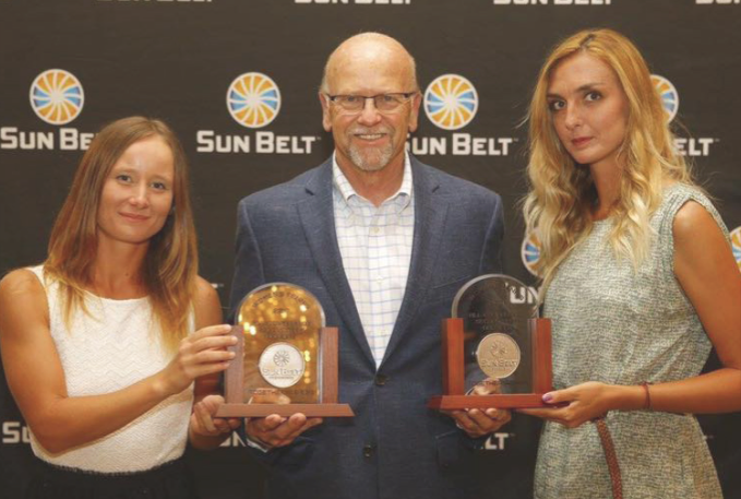 Stefana Andrei and Petra Horakova show off their awards at the ceremonies held before the conference tournament.  Photo by ULM Athletics.