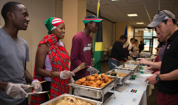 International students from Kenya serve cusine from their country during International Week. Photo by Siddharth Gaulee.