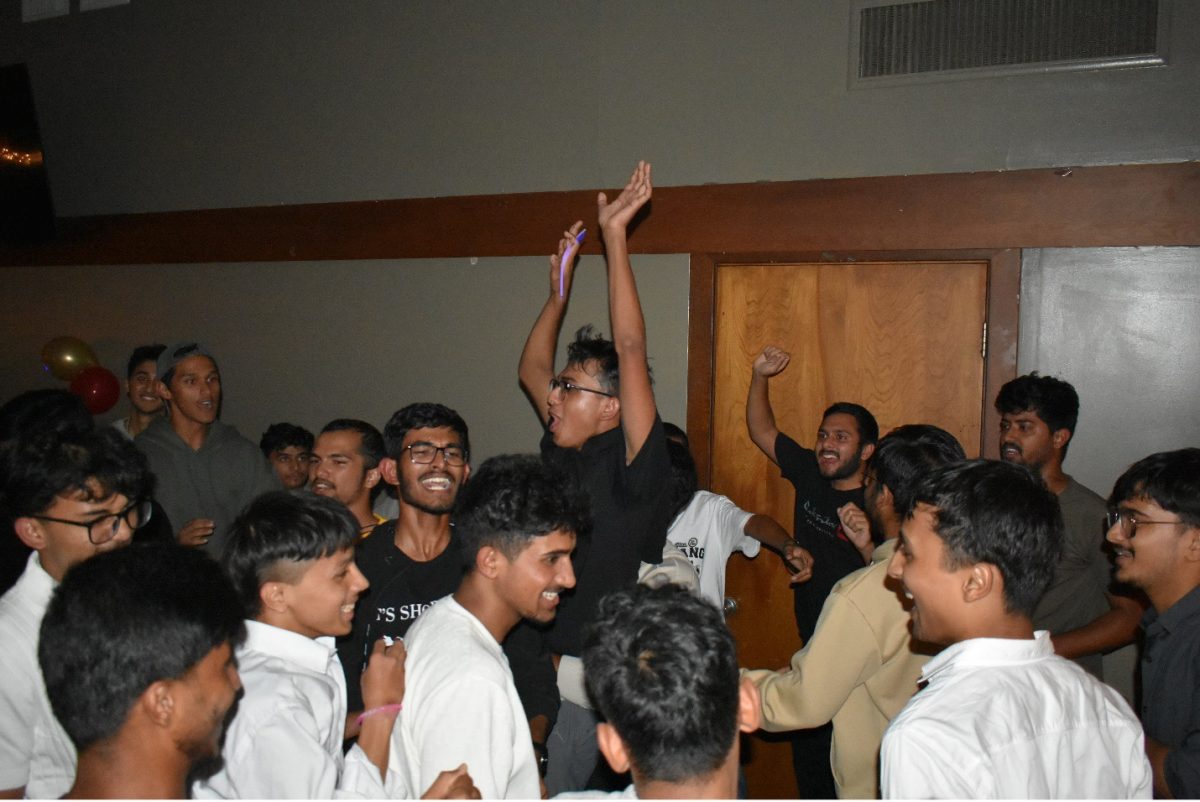 HANDS IN THE AIR: Students dance to traditional Nepalese music.