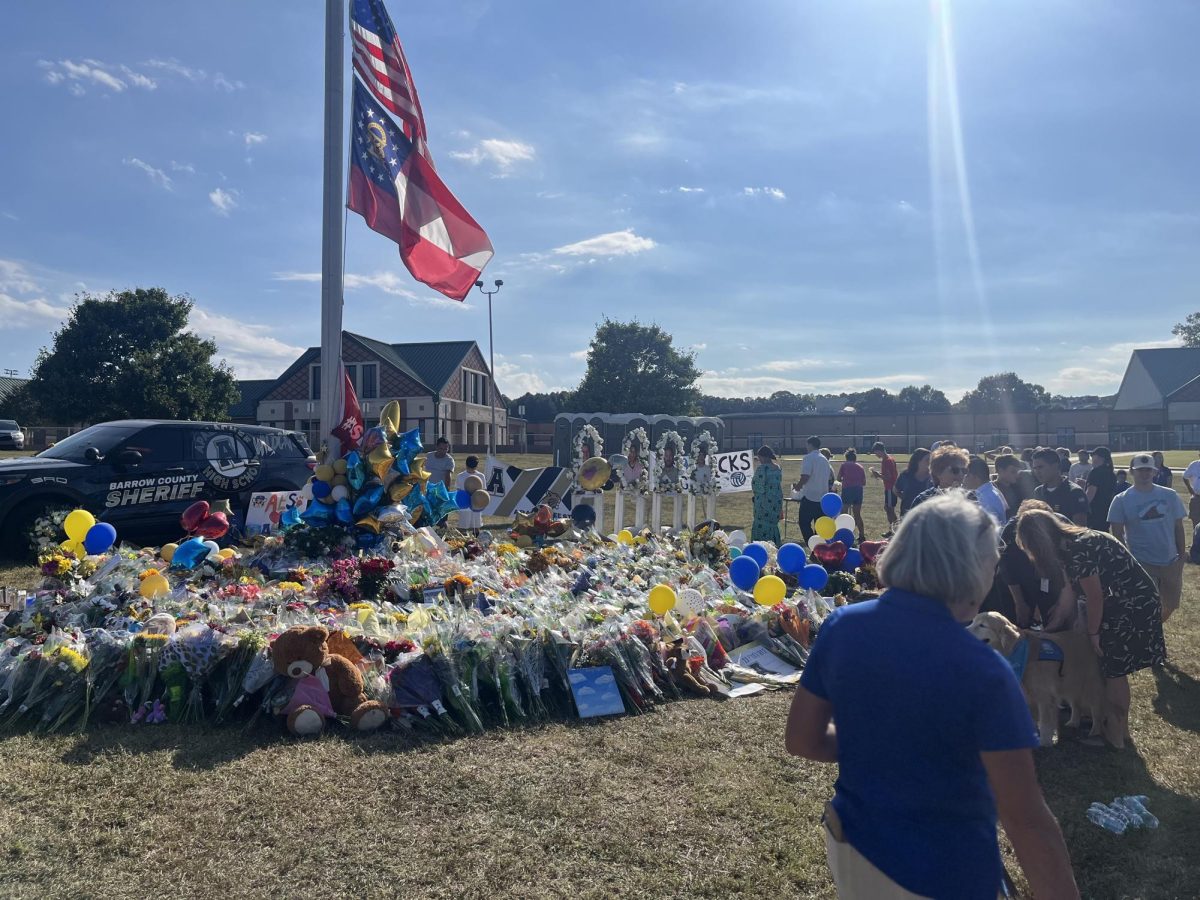 EFFECTS OF GUN VIOLENCE: Mourners of the shooting at Apalachee High School create a memorial for the fallen.