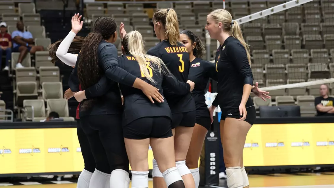 The Warhawks celebrate points with a team huddle. 