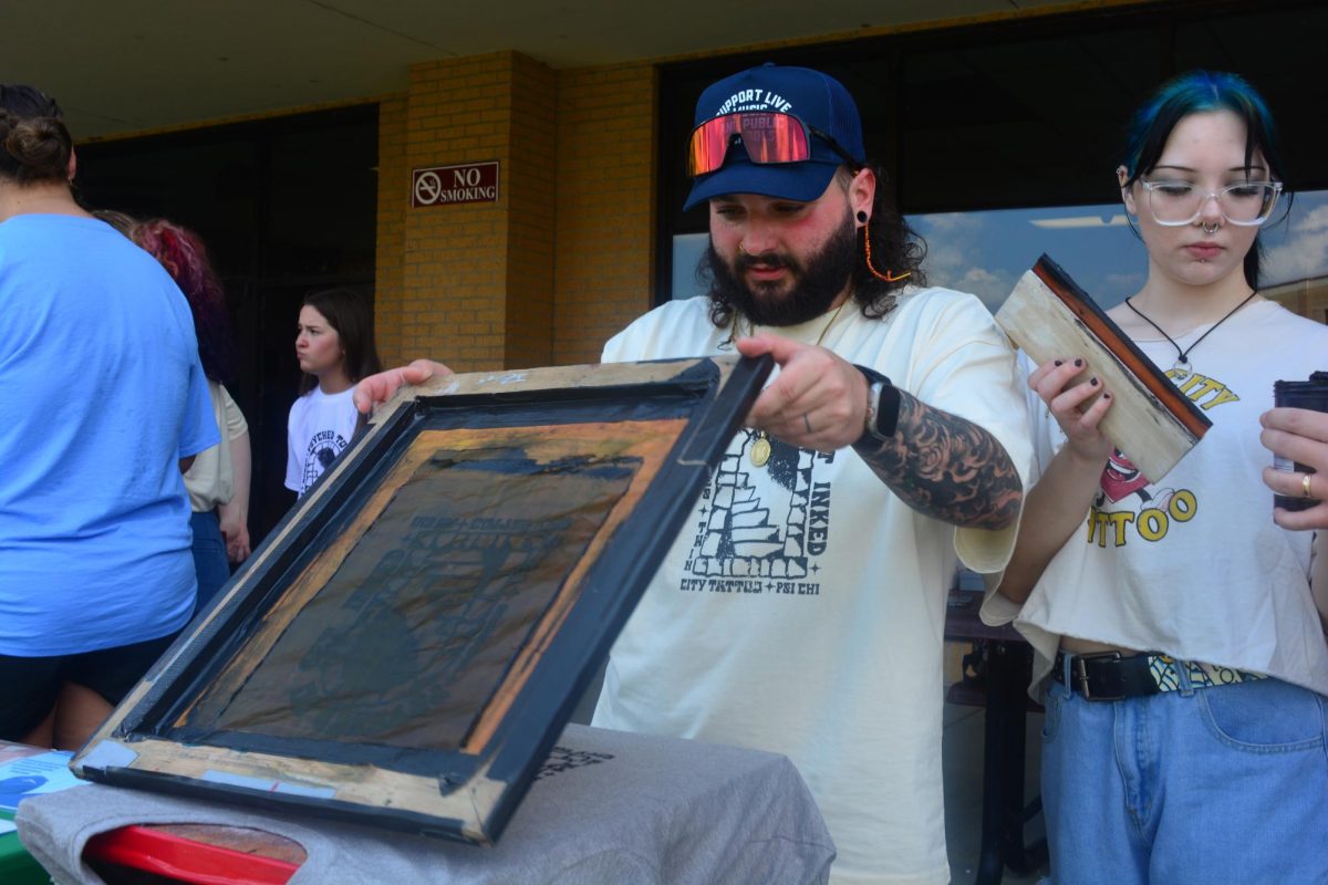 Caleb Powell showcasing how Twin City Tattoos screen prints their t-shirts to support Psi Chi. All profits went to Psi Chi in support of Suicide Prevention Month.  