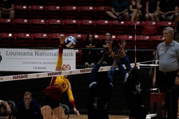 Jackson State players try to block while ULM Warhawks outside hitter Madison Derden (10) strikes the ball.