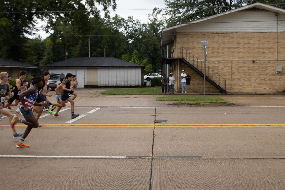 Participants rush towards the finish line in front of Hemphill Hall. 