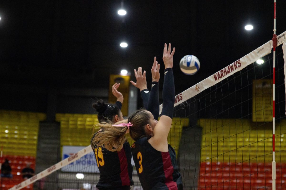 Amelia Piekut (3) right side hitter and Beril Celik (19) middle blocker both jumped to block a hit from South Alabama. 