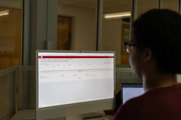 The Hawkeye’s opinion editor Madison Terry completing timesheet for the week.