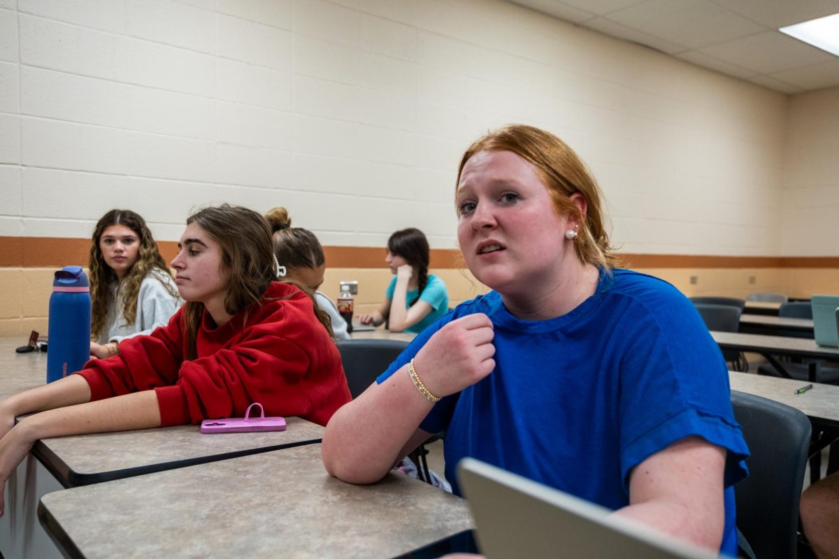 HOT IN HERE: Students struggle to focus on lecture material as they try to cool off.