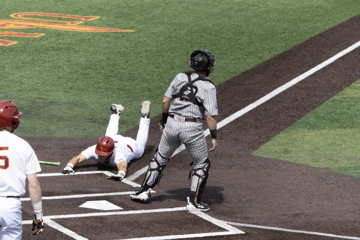 ULM baseball Catcher #3 Zach White sliding in at home plate.